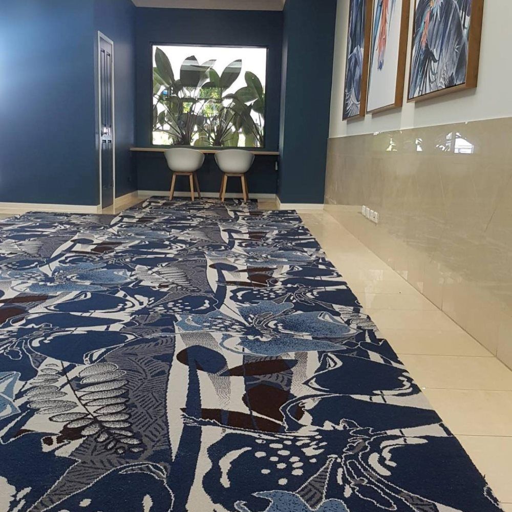 A Hallway with A Carpet that Has a Pattern of Birds on It — John Chisholm Flooring in Manunda,  QLD