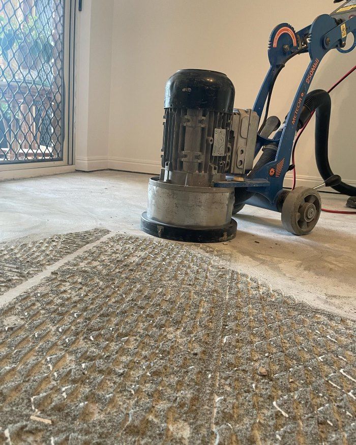 A Machine is Sitting on the Floor in a Room — John Chisholm Flooring in Manunda,  QLD