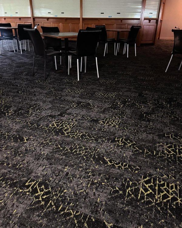 A Room With Tables and Chairs on the Floor — John Chisholm Flooring in Manunda,  QLD