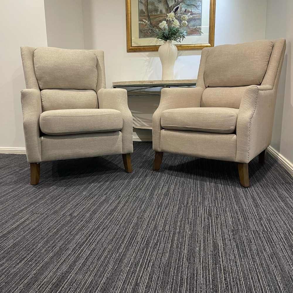 Two Chairs Are Sitting Next to Each Other on a Carpet in a Room — John Chisholm Flooring in Manunda, QLD