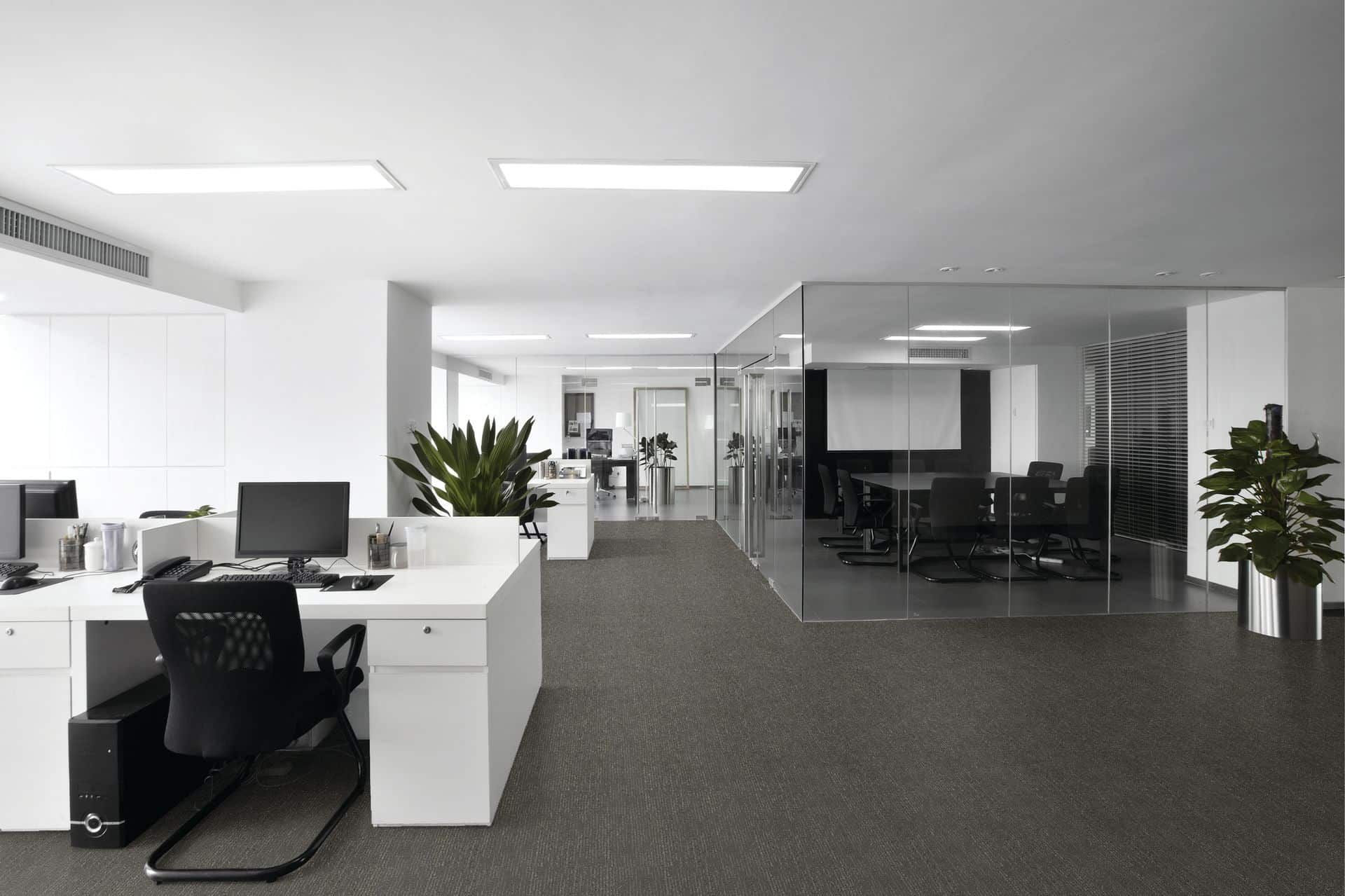 An Empty Office With a Lot of Desks and Chairs — John Chisholm Flooring in Mission Beach,  QLD