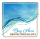 A logo for bay area dental specialists with a blue and green wave