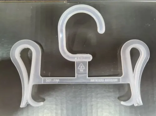 Percha de ropa de plástico transparente con pinzas para pantalones o faldas.