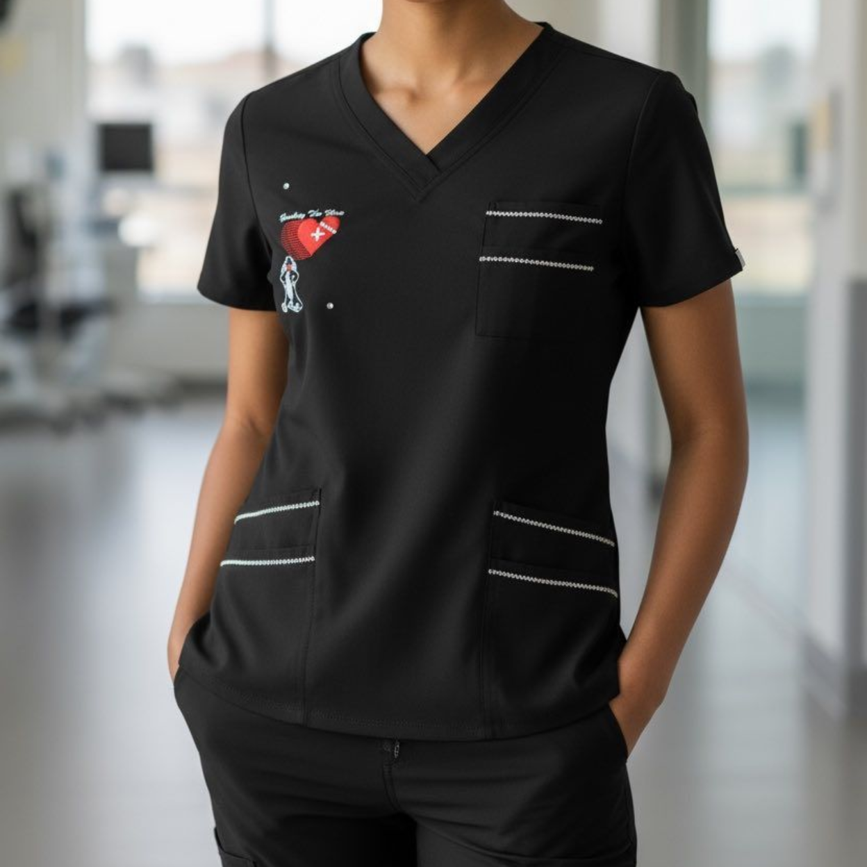 Black medical scrub top with wine glass design and white trim.