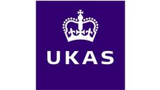 A purple square with a white crown and the word ukas on it.