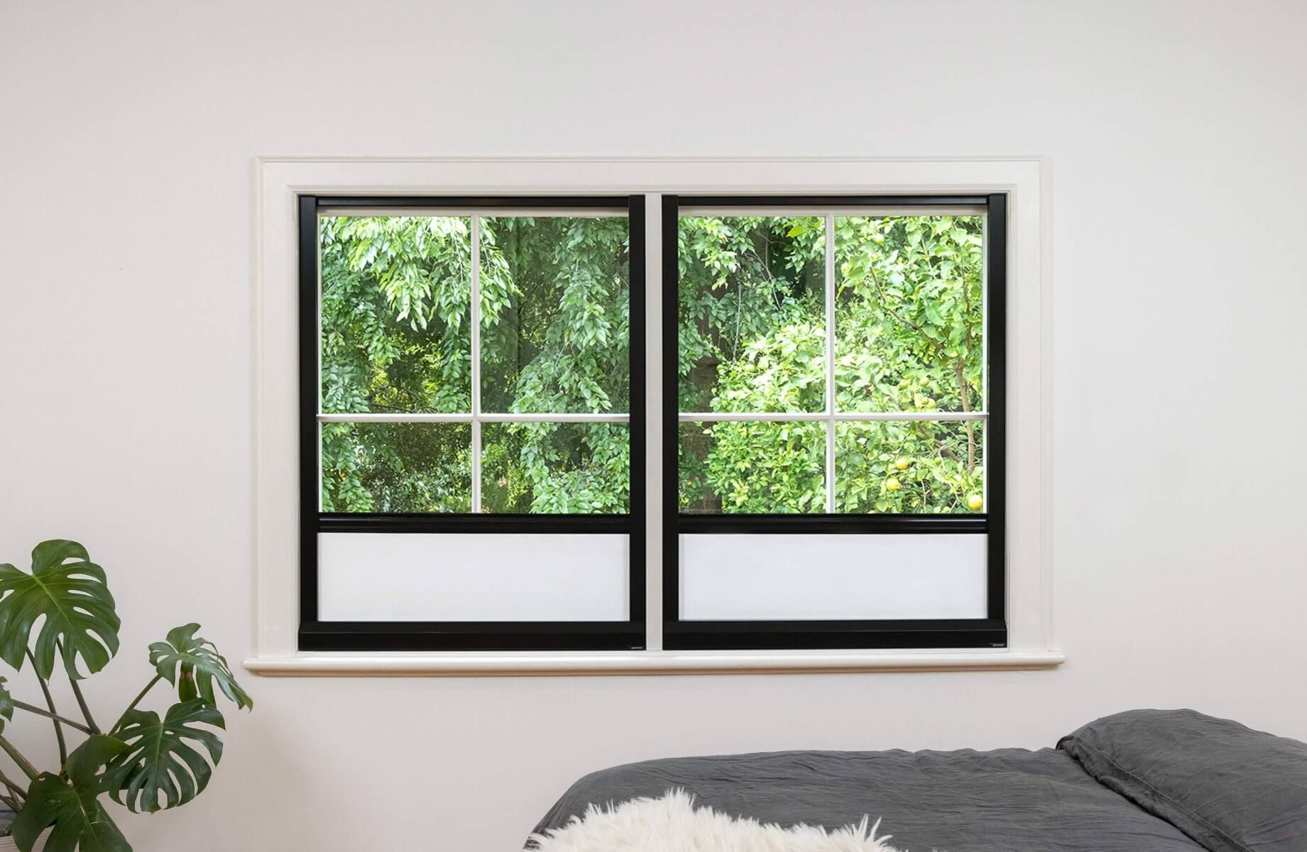 Black frame and white fabric full blackout blinds for dual narrow windows, inside installation on lower window sill.