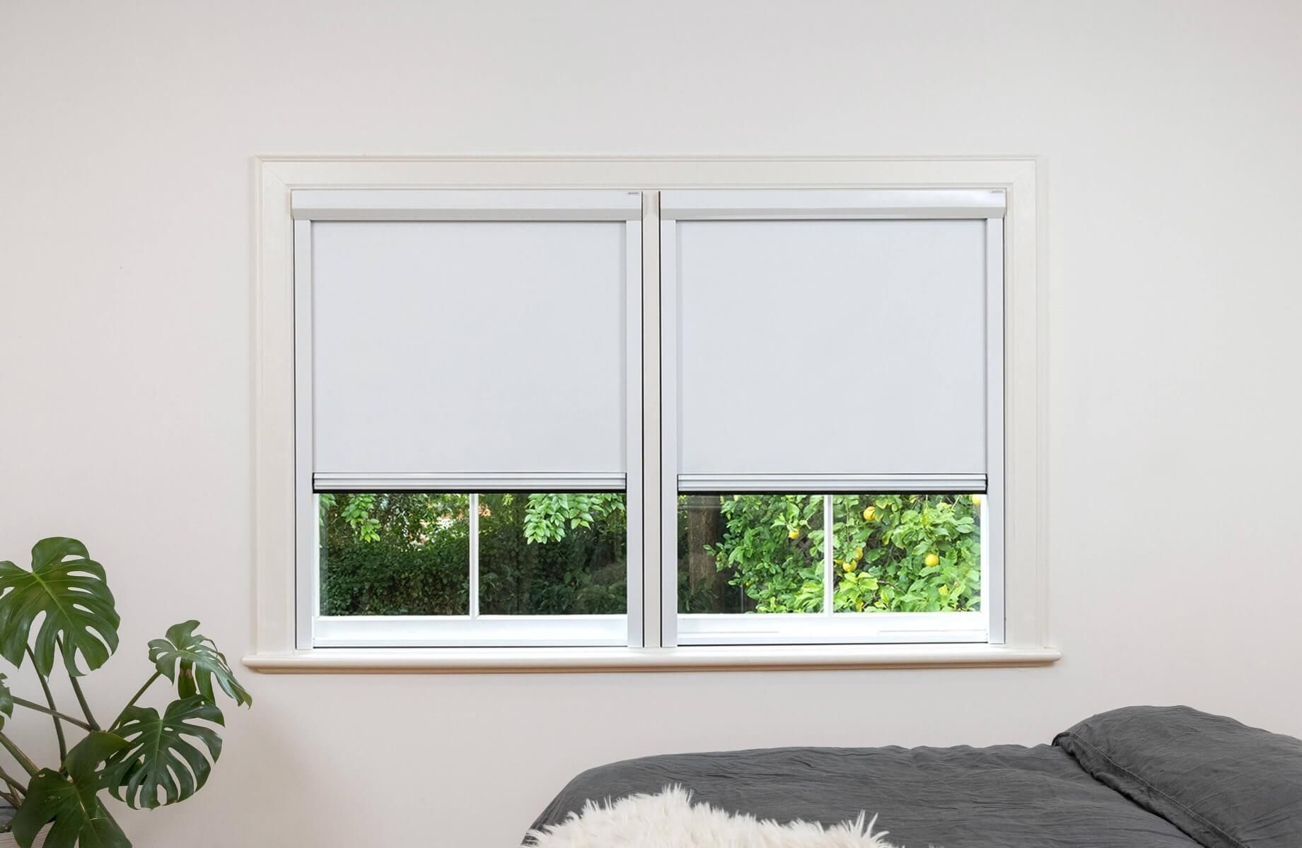 White frame and white fabric full blackout blinds for dual narrow windows, inside installation.