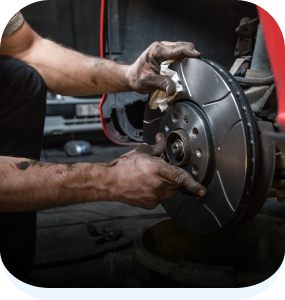 Technician working on brakes of vehicle | Automotive Repair Specialists