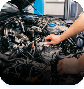 Man repairing engine under hood | Automotive Repair Specialists