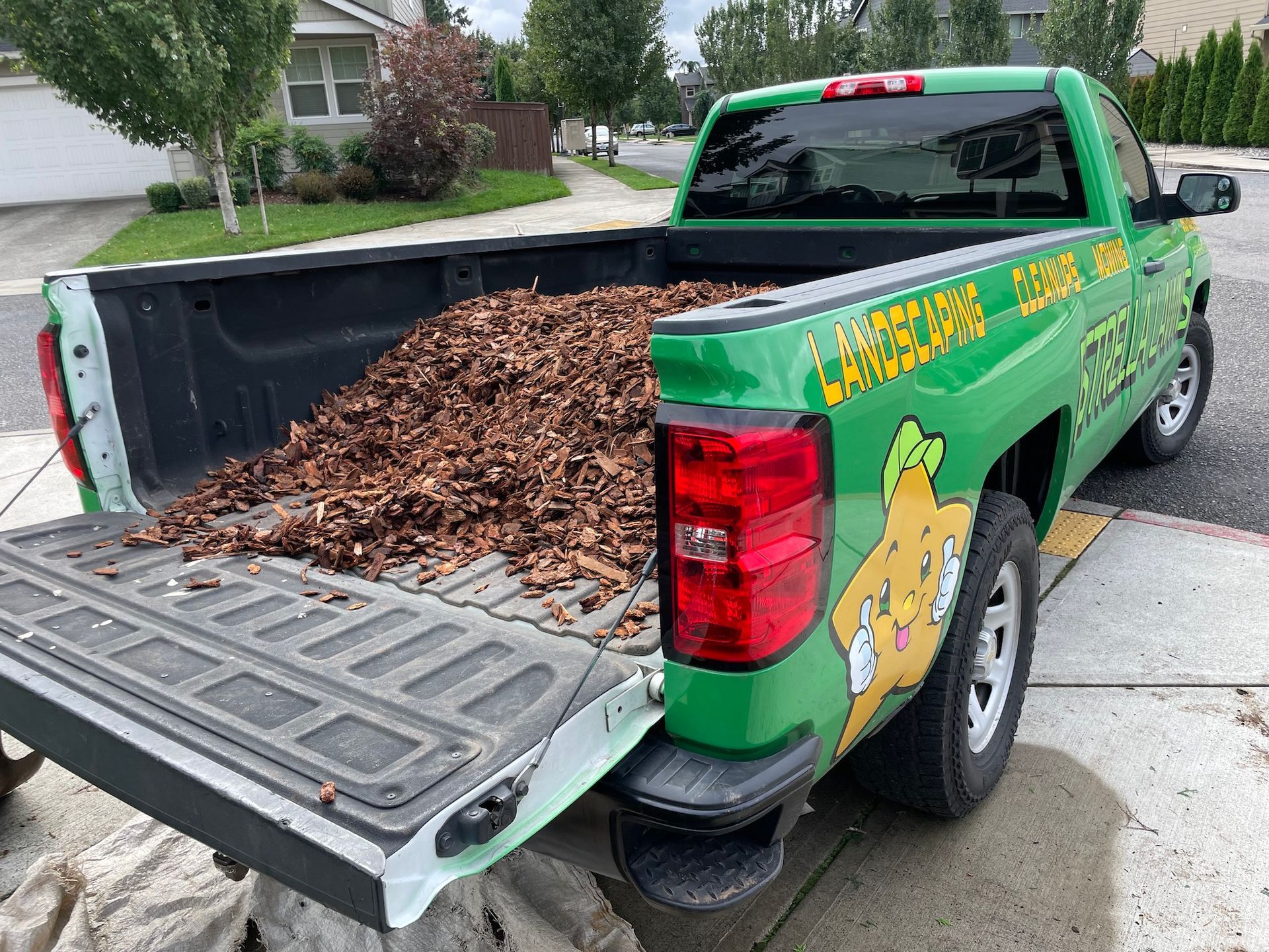 a green truck with the word landscaping on it