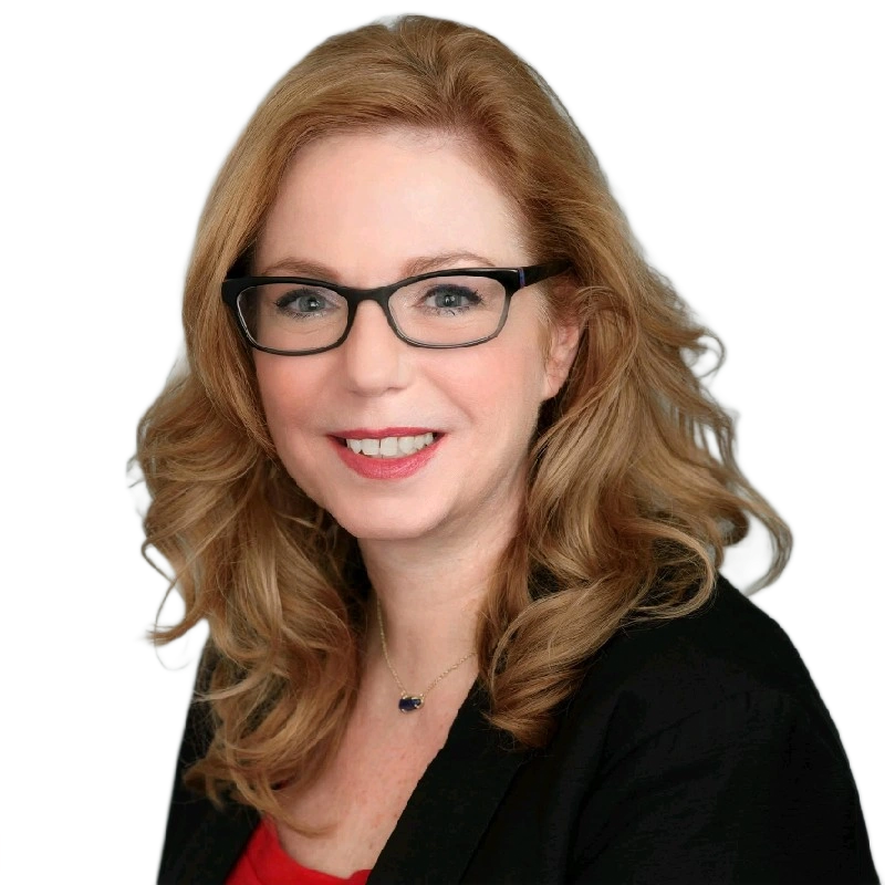 Woman with glasses, smiling, wearing a black blazer over a red top.