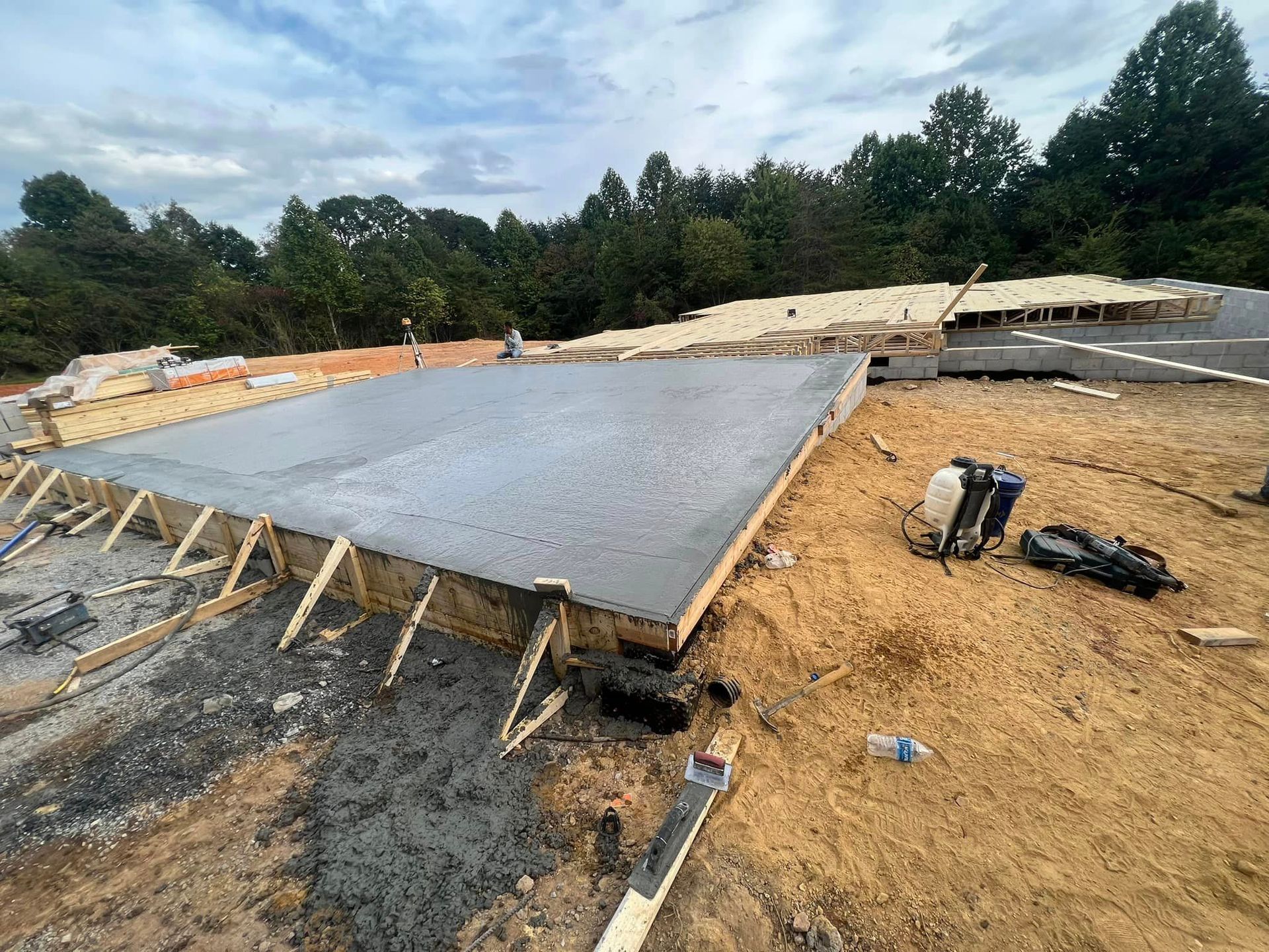 A concrete foundation is being built on top of a dirt field.