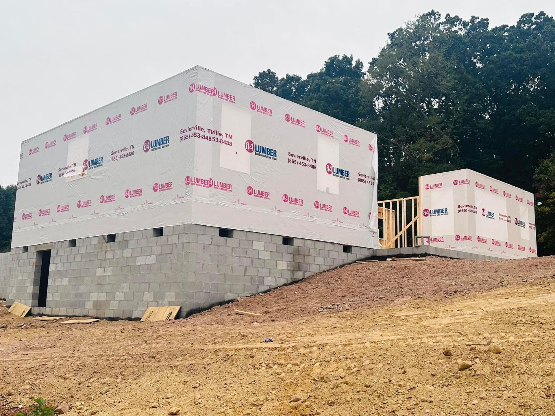 A house is being built on top of a dirt hill.