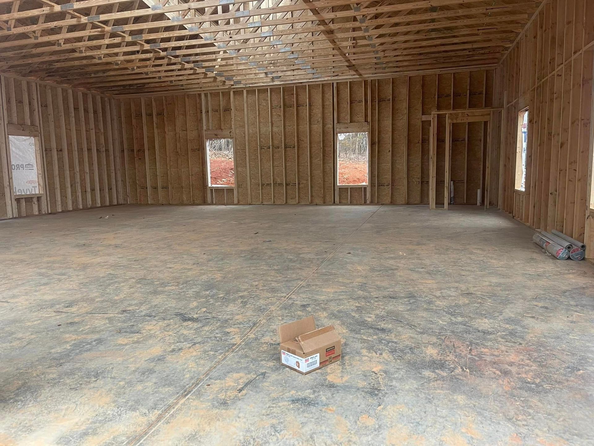 The inside of a building under construction with a box on the floor.