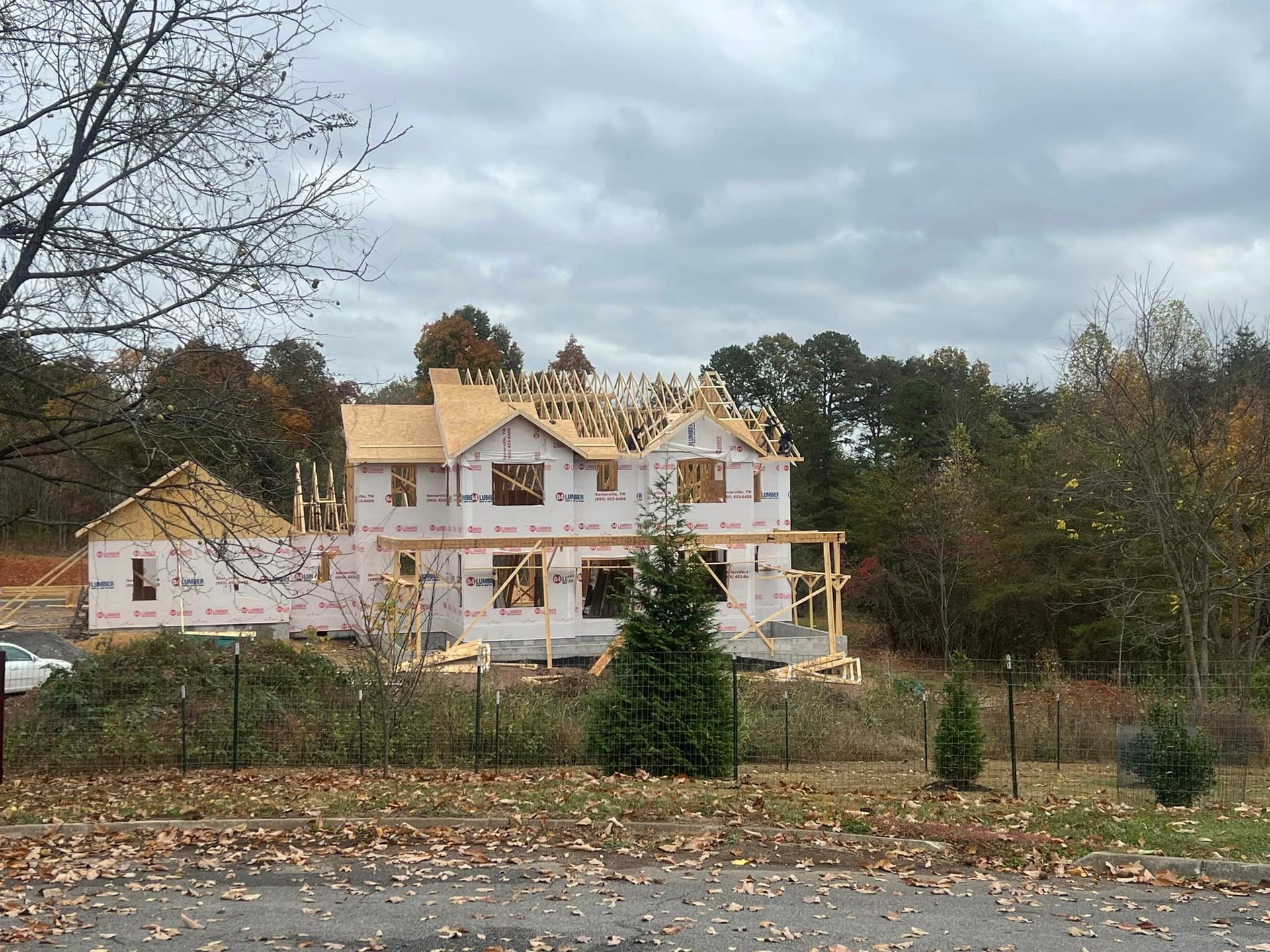 A large house is being built in the middle of a forest.