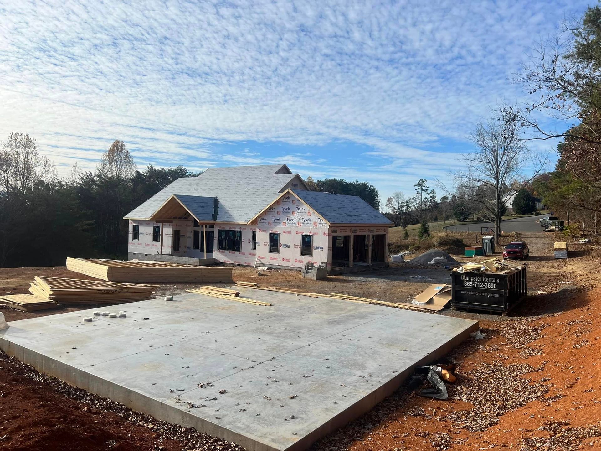 A house is being built in the middle of a dirt field.