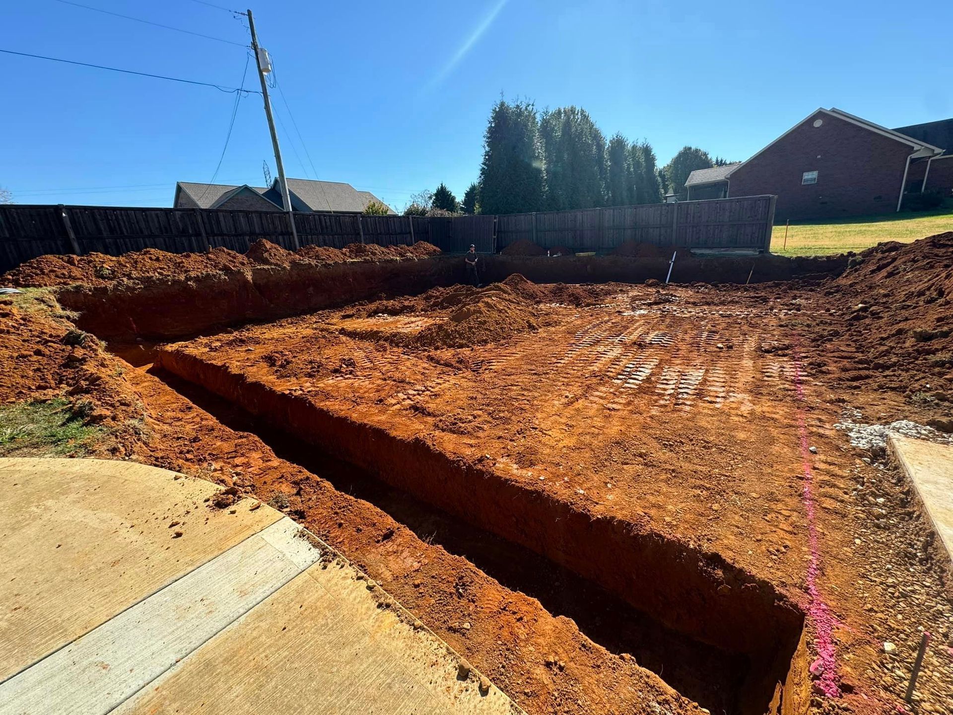 A large pile of dirt is sitting in front of a house.