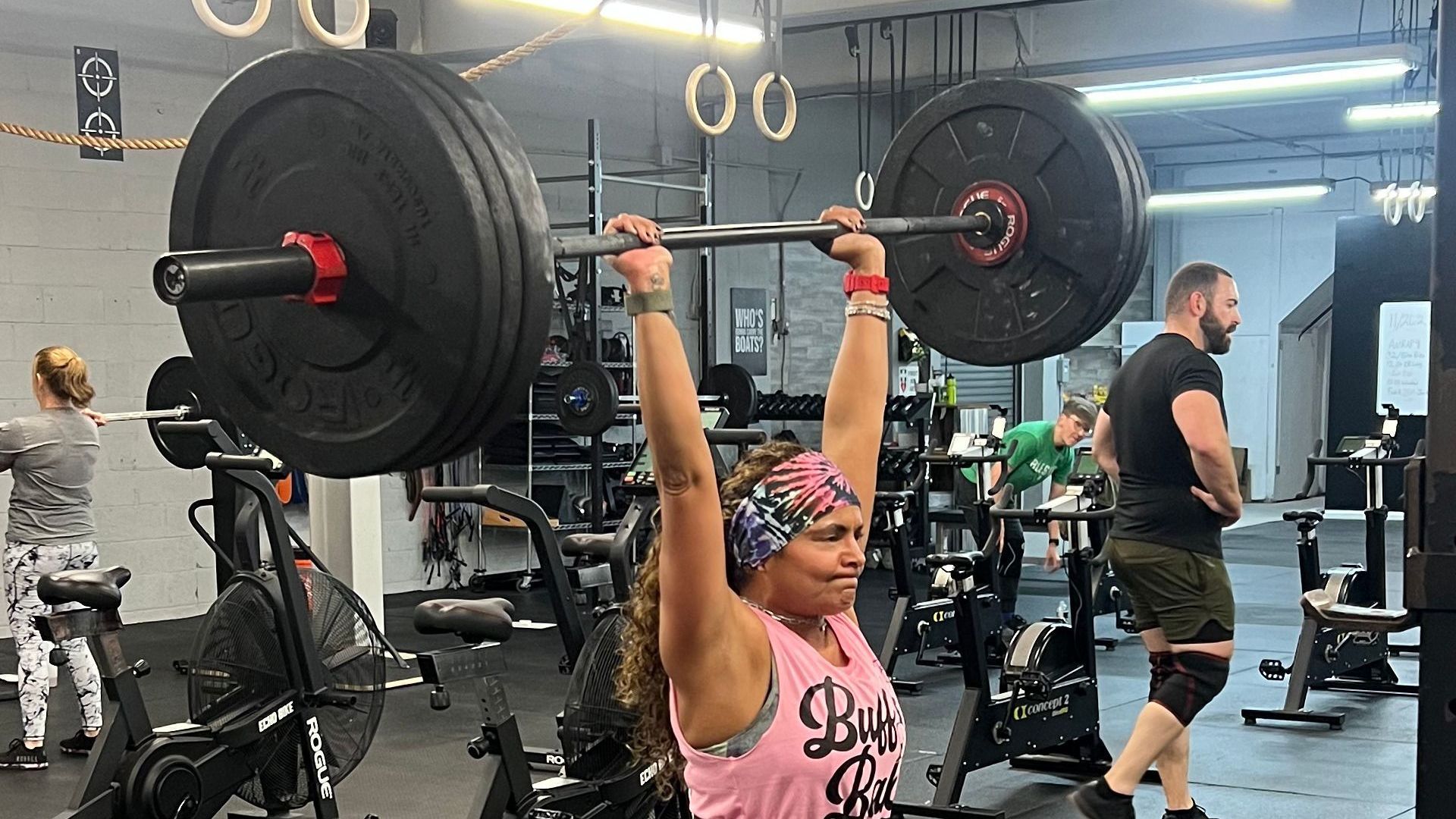 A woman performing a lift in the gym.