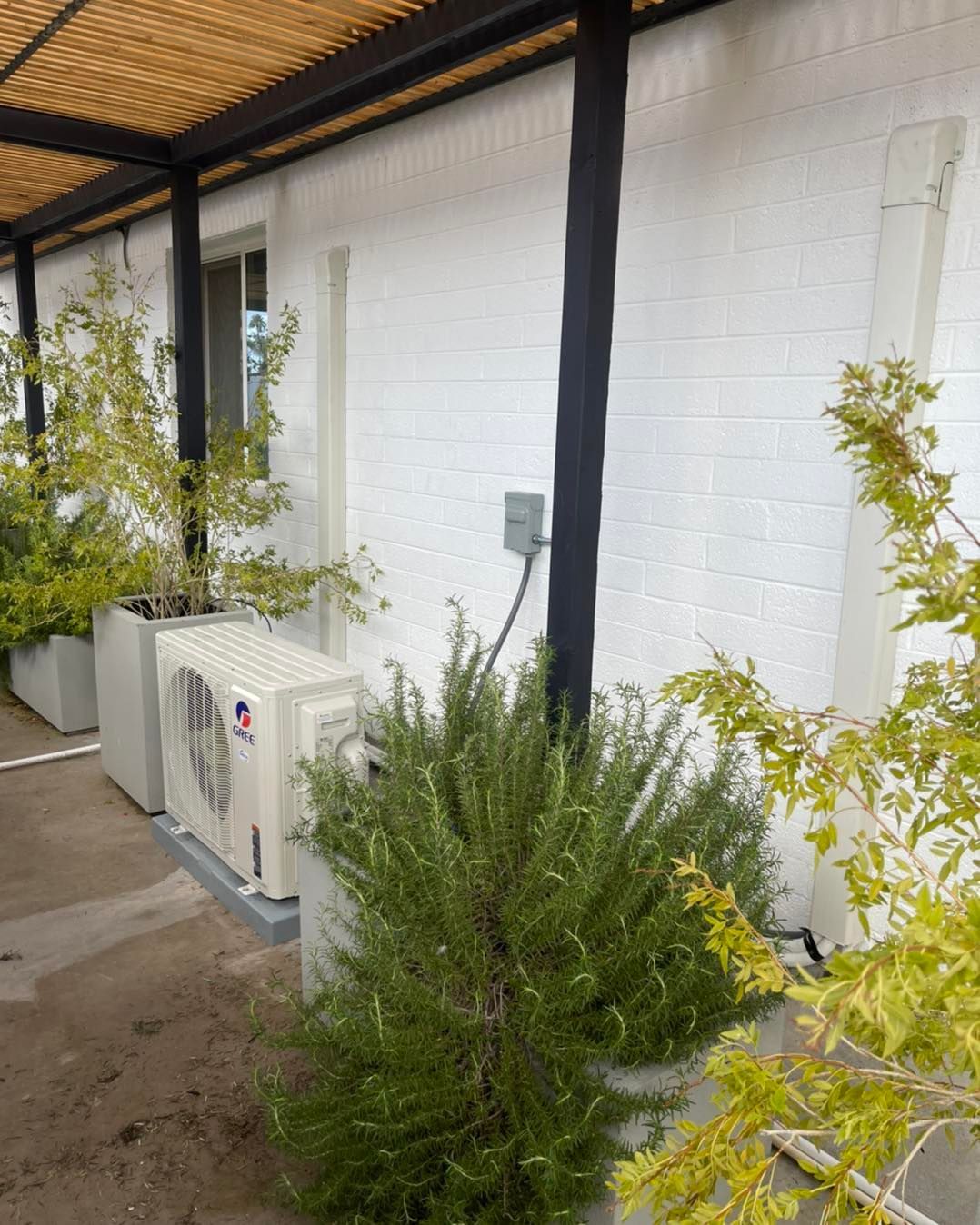 A white house with a large air conditioner on the side of it