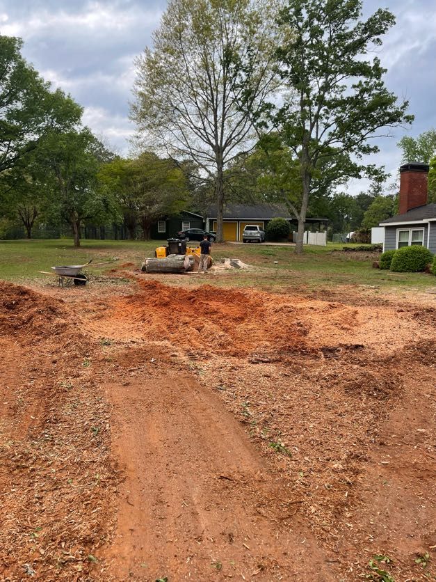 A large pile of dirt is in front of a house.