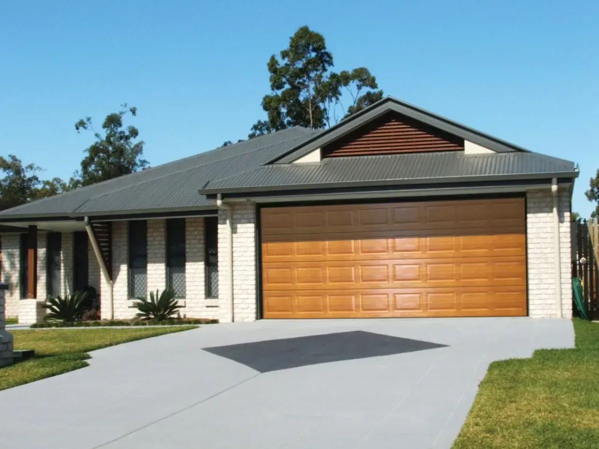 House with Wood Color Garage Door — Hastings Garage Door Services in Port Macquarie