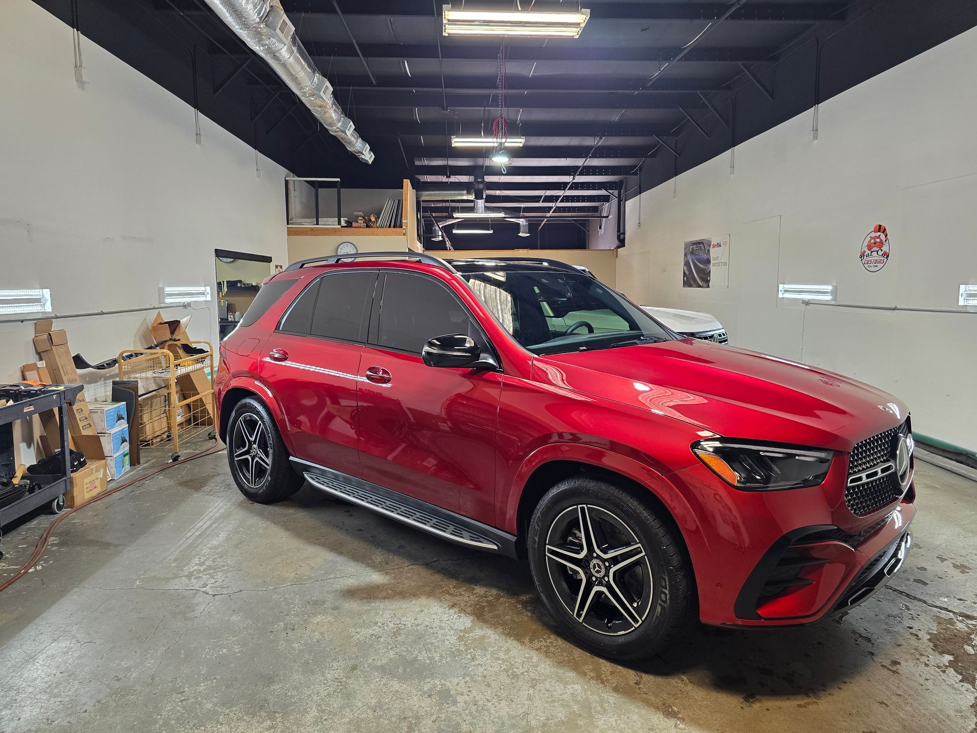 Interior of a gray BMW SUV with black leather seats and digital dashboard. Steering wheel is centered.