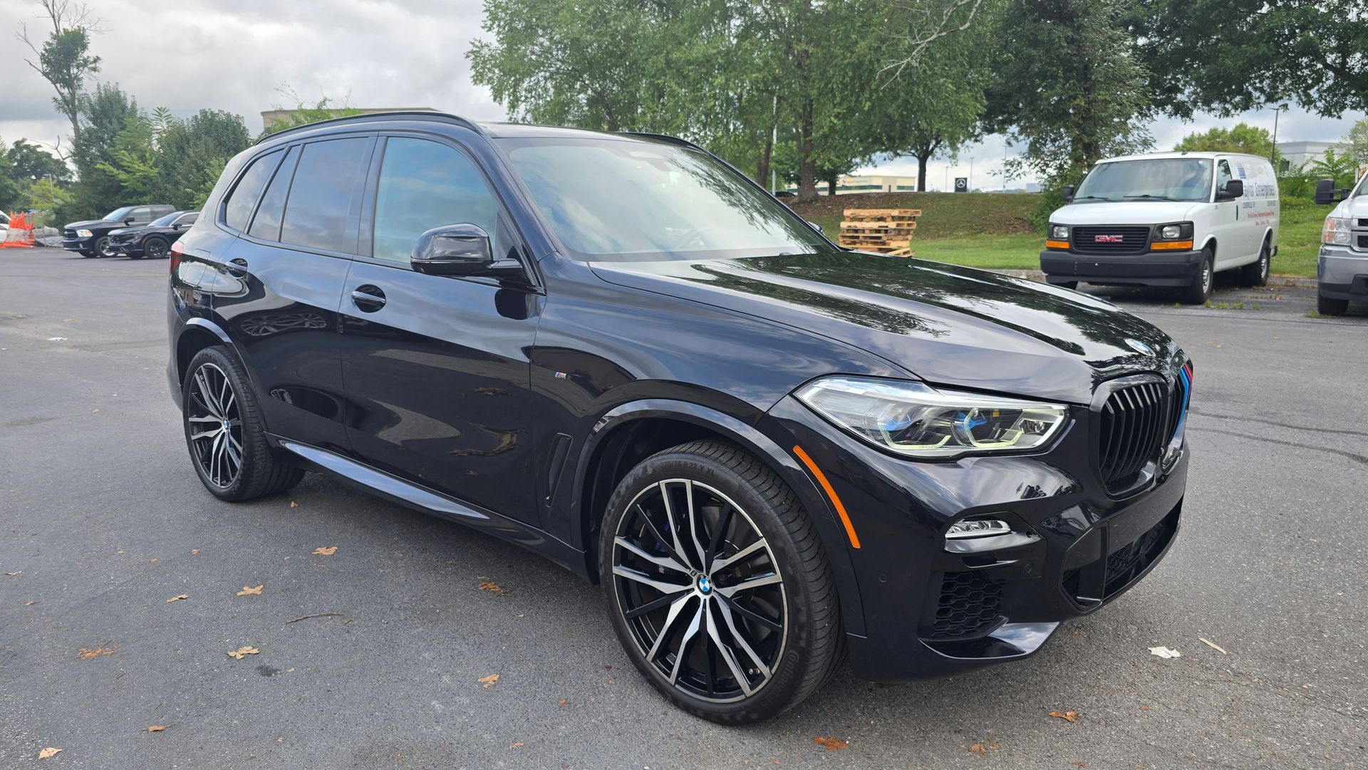 Interior of a gray BMW SUV with black leather seats and digital dashboard. Steering wheel is centered.