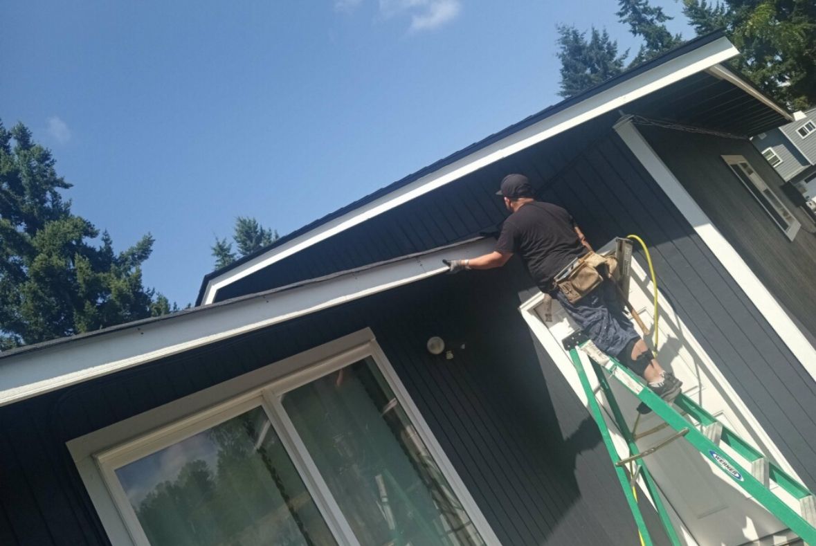 Worker Painting Roof — Lacey, WA — Seamless Gutters Troy Services LLC