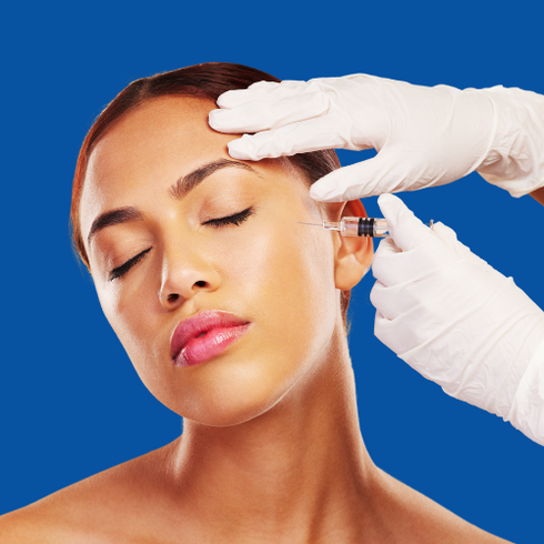 Person receiving facial injection; gloved hands, blue background.