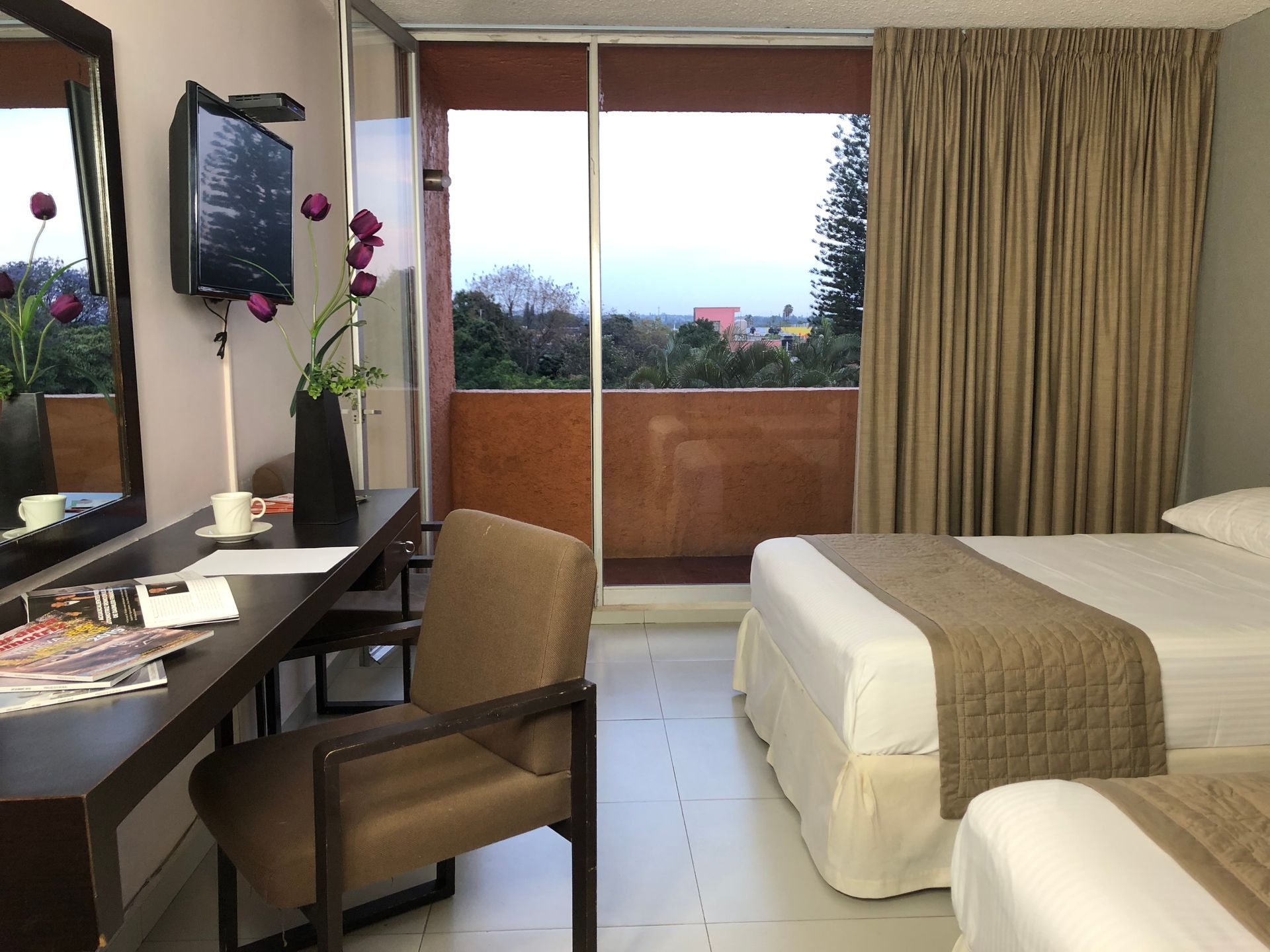 Una habitación de hotel con dos camas y un escritorio.