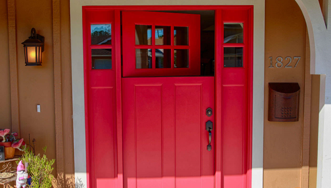 Red front door with sidelights, mailbox, and house number 1817.