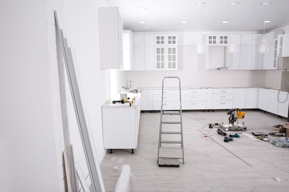 A Kitchen Under Construction With White Cabinets and a Ladder — Shane Rice Builder & Renovation Specialist In Southside, QLD