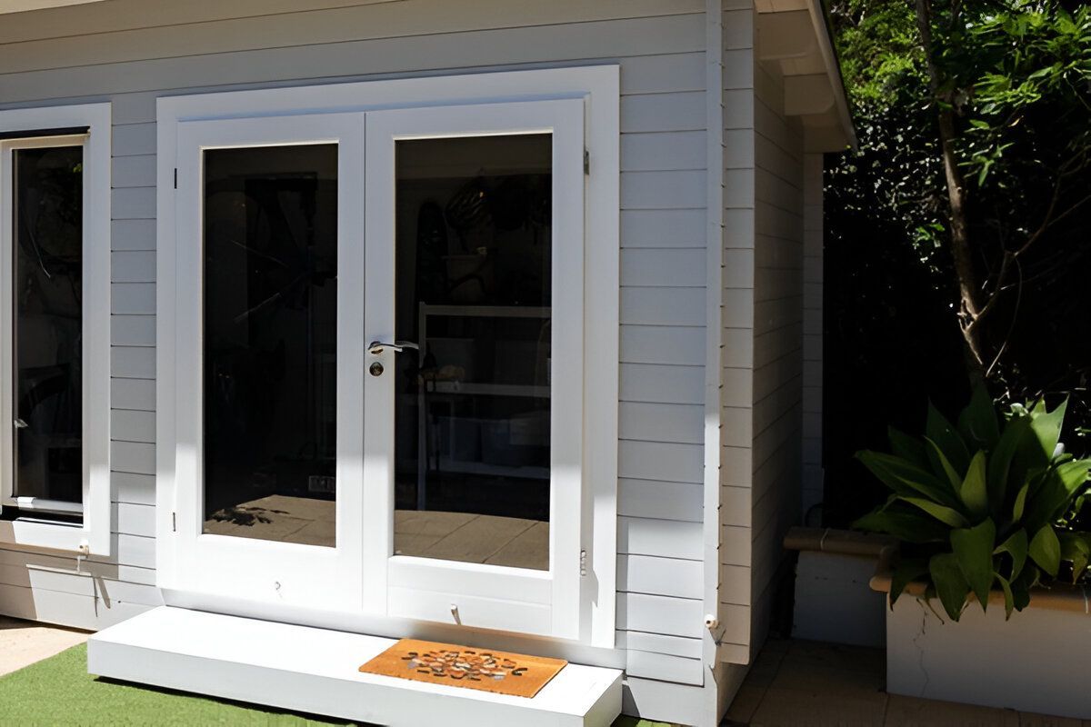 A White House With a Welcome Mat in Front of It — Shane Rice Builder & Renovation Specialist In Southside, QLD