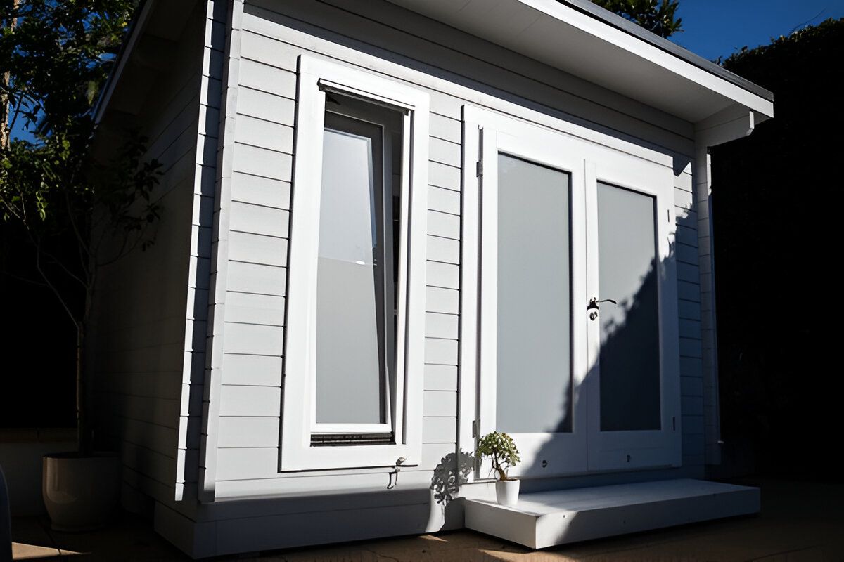 A White House With a Lot of Windows and Doors — Shane Rice Builder & Renovation Specialist In Southside, QLD