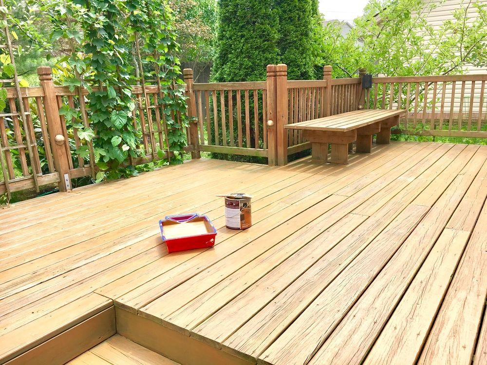 A Wooden Deck With a Bench and a Can of Paint on It — Shane Rice Builder & Renovation Specialist In Southside, QLD