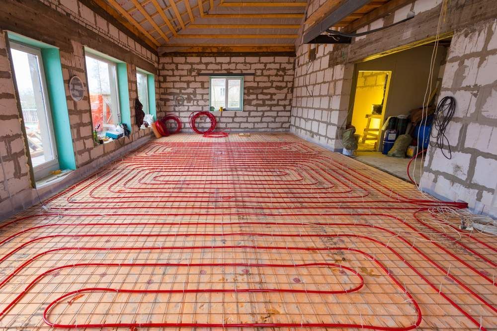 A Room Under Construction With a Heating System on the Floor — Shane Rice Builder & Renovation Specialist In Southside, QLD