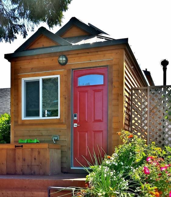 A Small Wooden House With a Red Door — Shane Rice Builder & Renovation Specialist In Southside, QLD