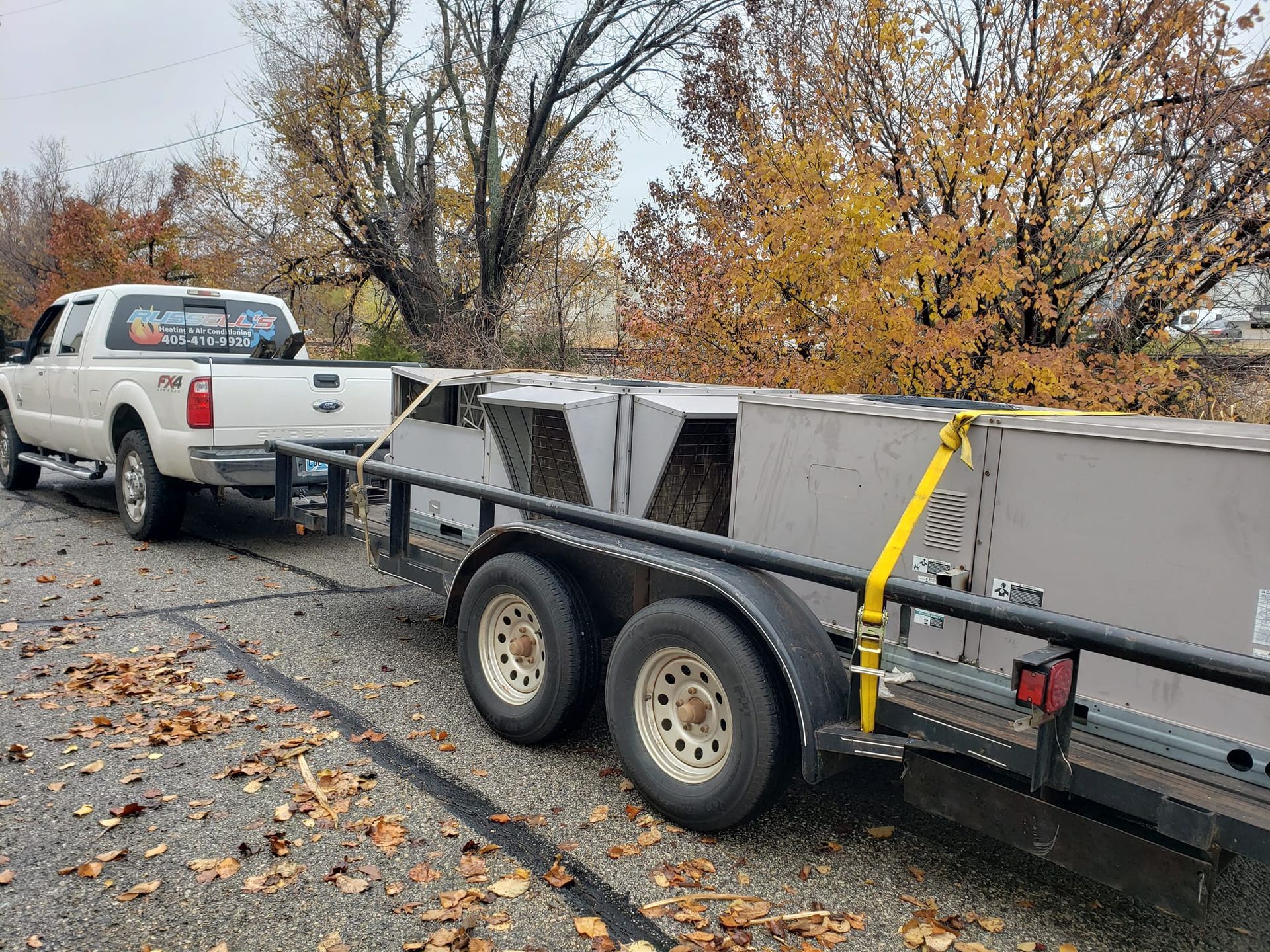 A truck is pulling a trailer with a boat on it.