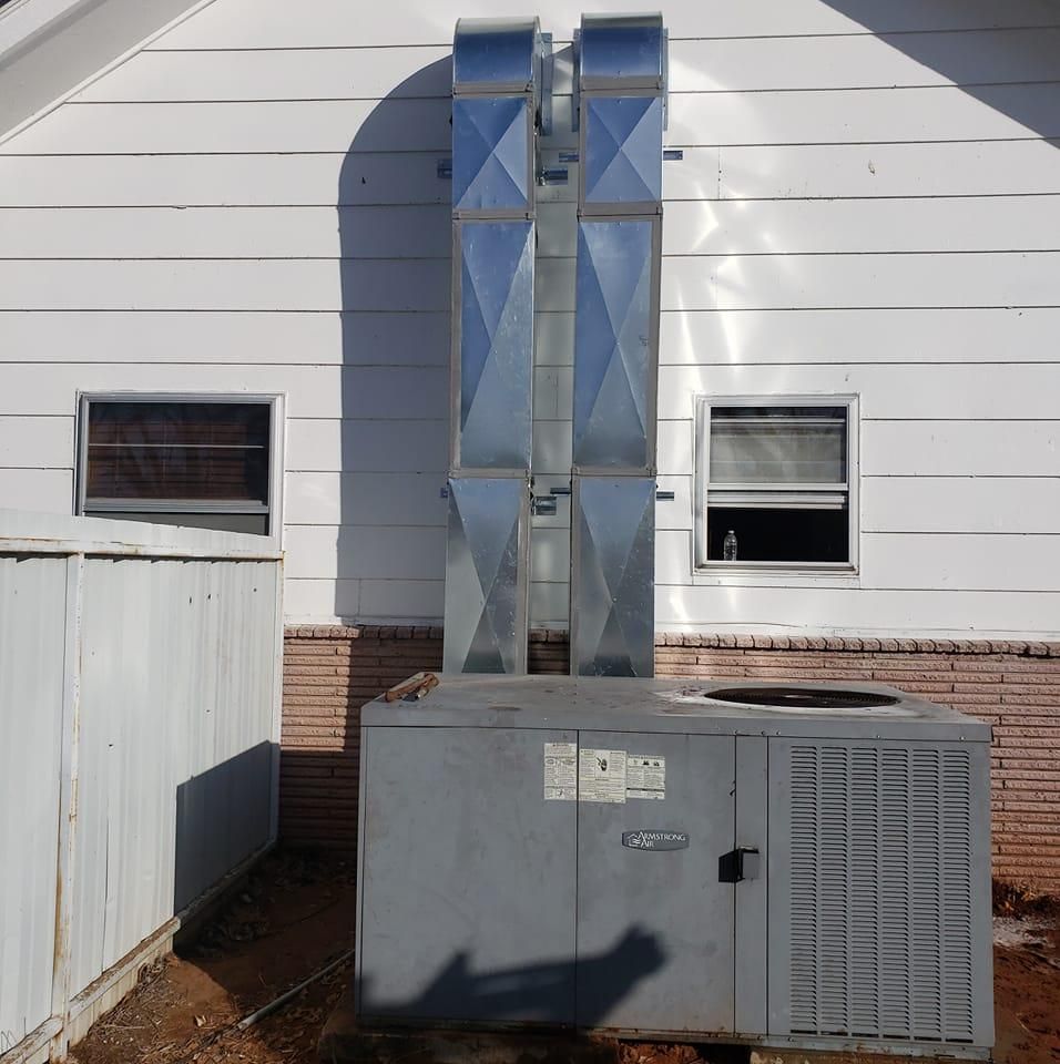 A white house with a gray box in front of it