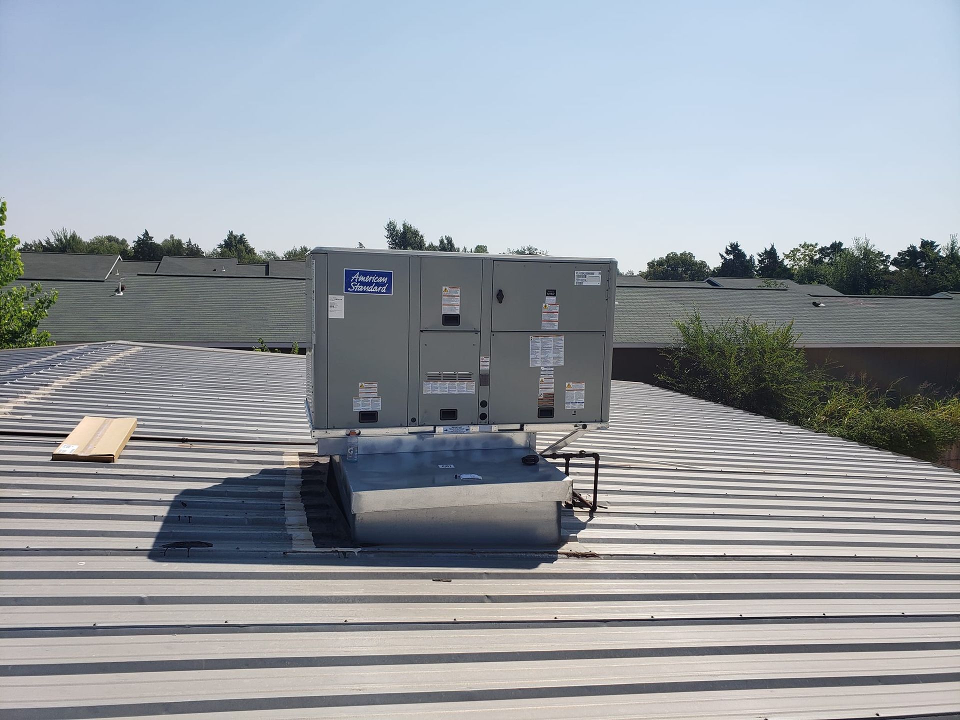 An air conditioner is sitting on top of a roof
