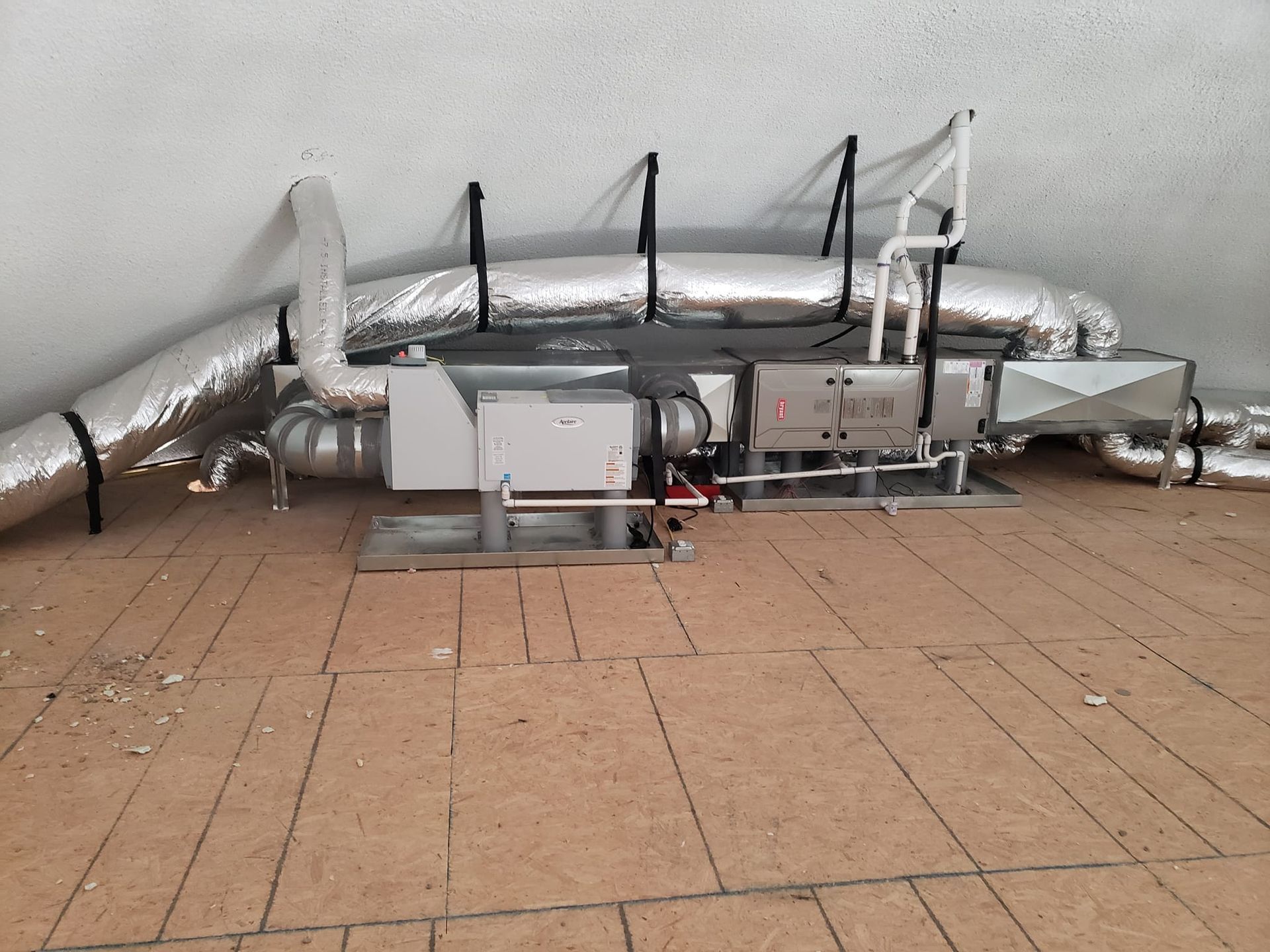 A bunch of pipes are connected to a wall.