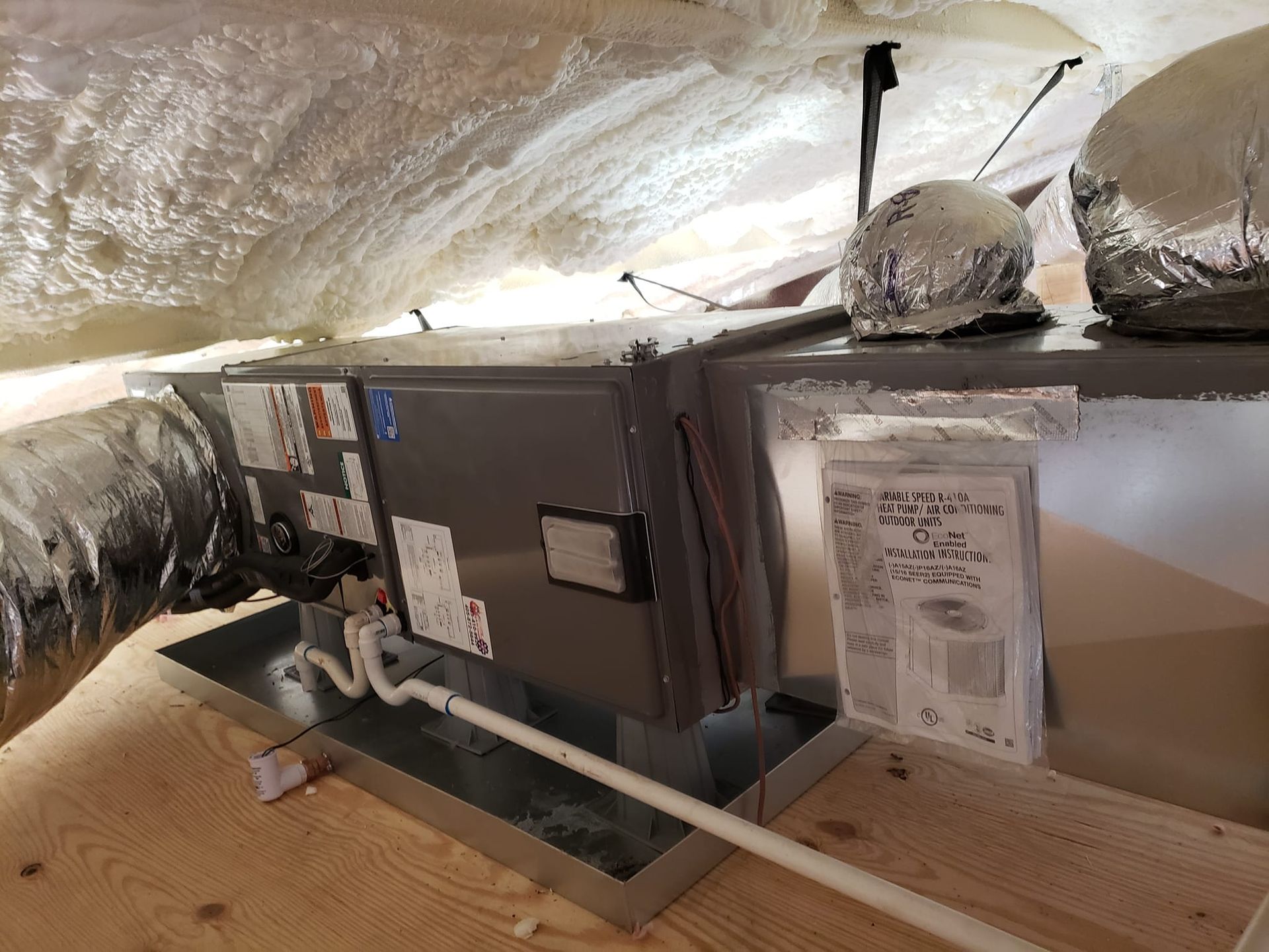 An air conditioner is installed in the attic of a house.