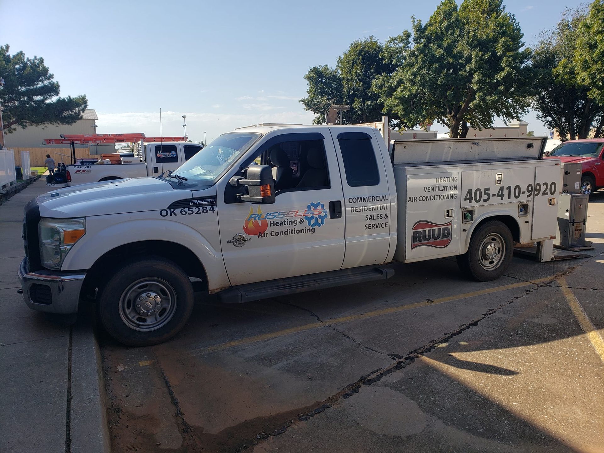 A white truck is parked on the side of the road.