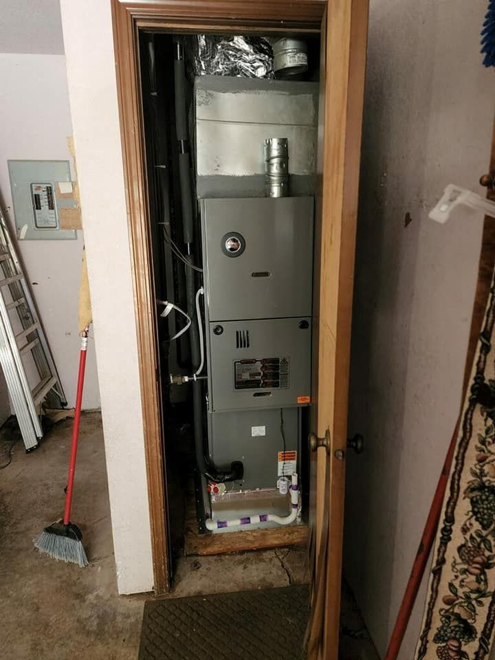 An air conditioner is installed in a doorway in a room.