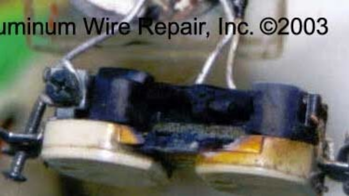 A picture of a broken electrical outlet from aluminum wire repair inc.