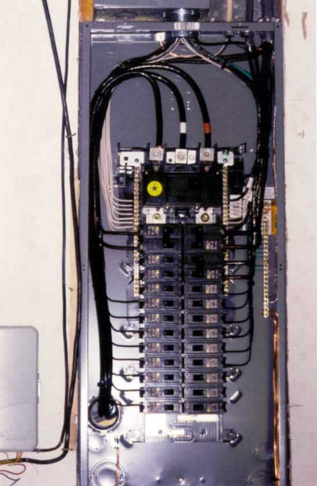 A black electrical panel with a yellow o on it