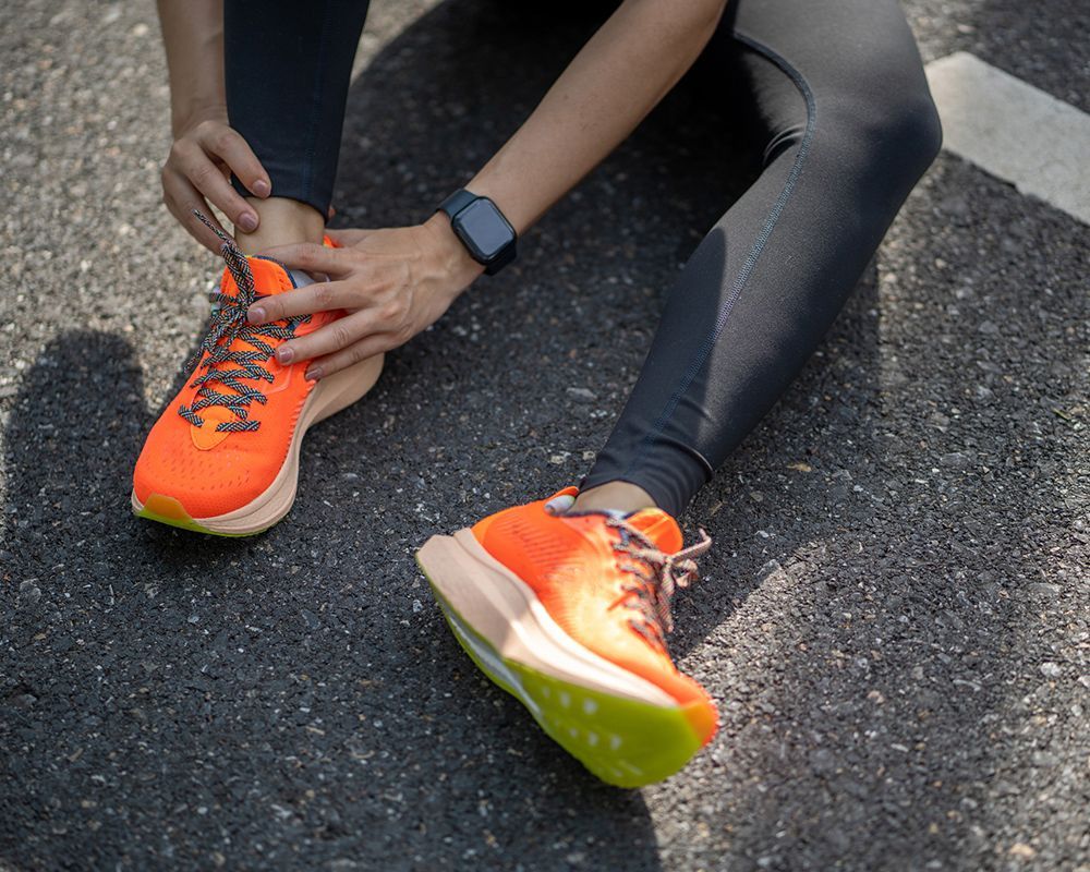 Women Holding Achilles Tendon Injury — Puyallup, WA — Froehling Hendricks