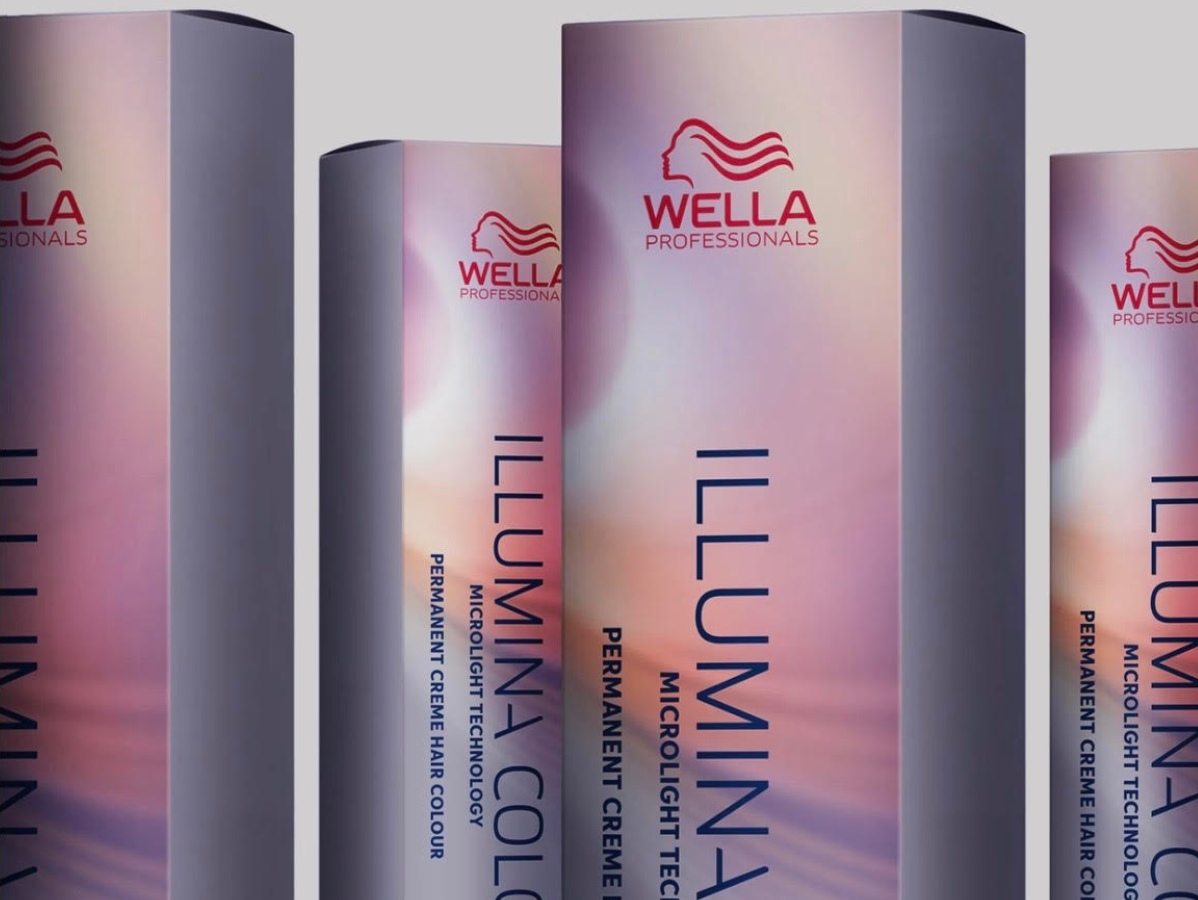 Several Wella Professionals Illumina Color hair dye boxes with a gradient purple and pink background.