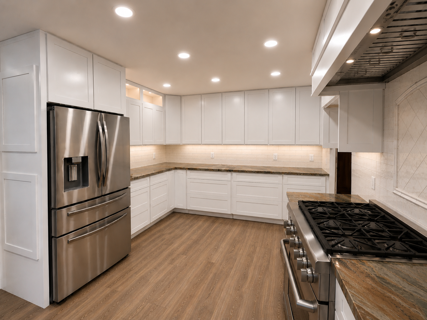 Modern white kitchen with stainless steel appliances, wood floor, and gas range island