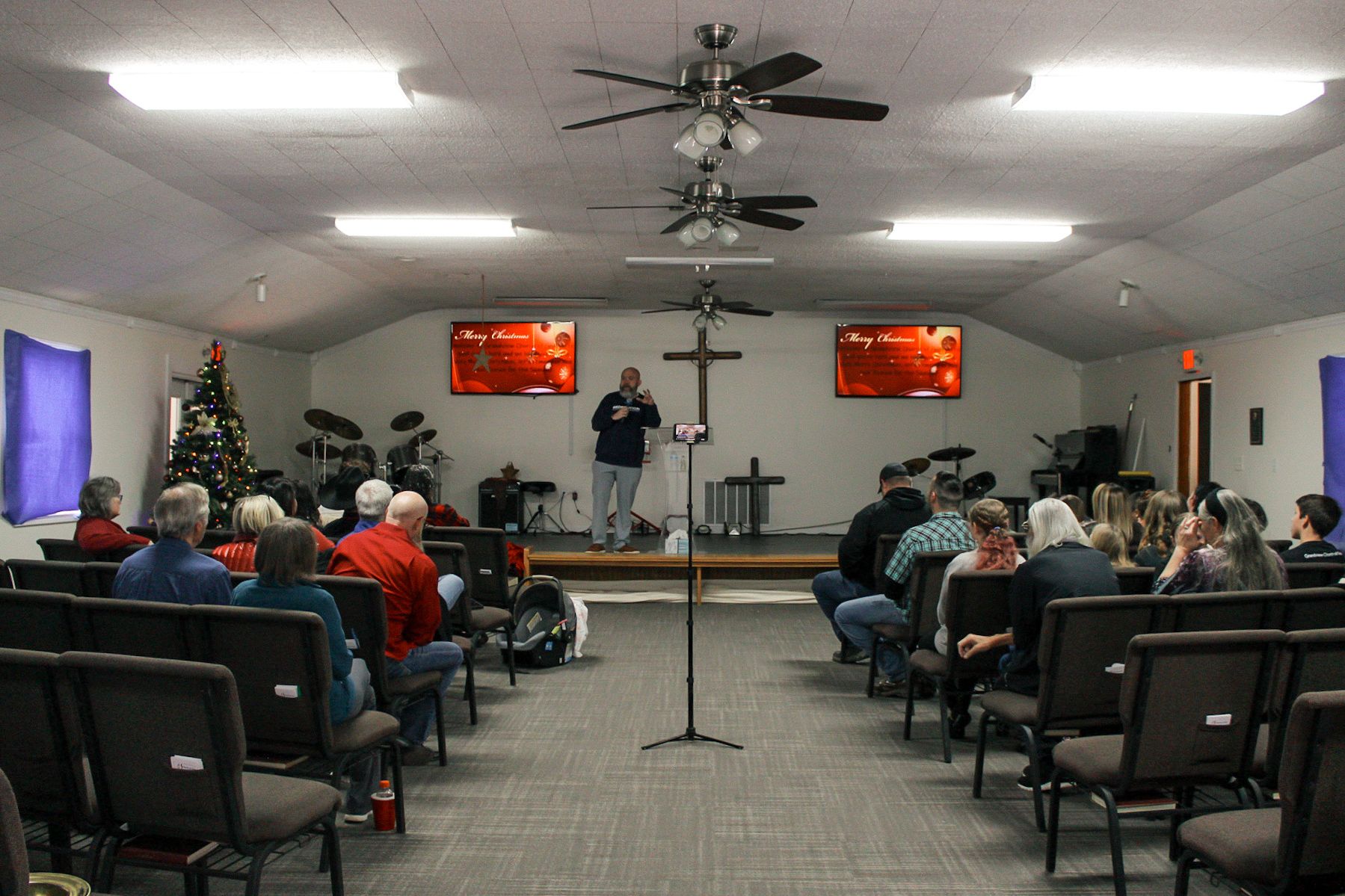 A man is giving a speech to a group of people in a church.
